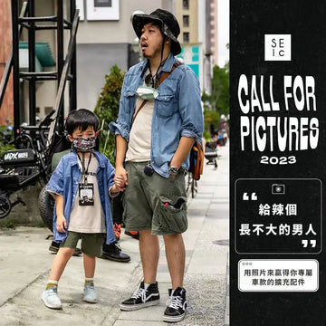 爸爸牽著小孩走在街上的照片